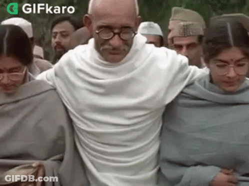 Mahatma Gandhi Walking Crowd White Shirt Glasses GIF