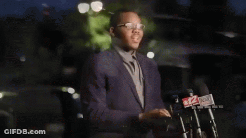 Malachi Love-Robinson In Suit At Microphones GIF