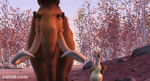 Mammoth And Squirrel Standing In Forest GIF