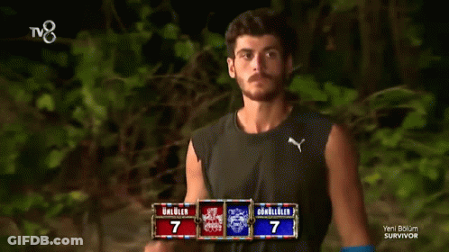 Man Adjusting Hair In Front Of Survivor TV GIF