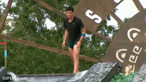 Man Adjusting Hair In Front Of Survivor TV GIF