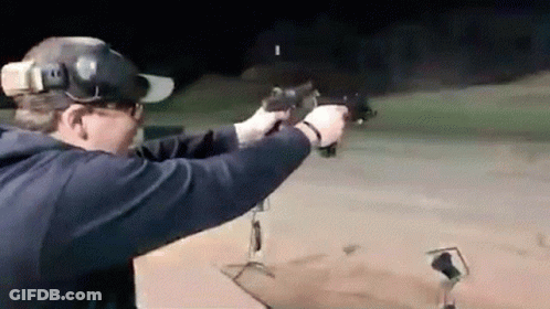 Man Aiming Gun At Target At Night GIF