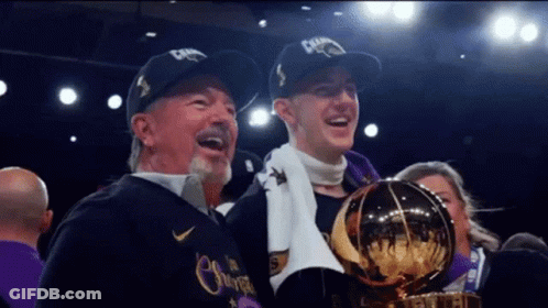 Man And Boy Holding Trophy With Champions Hats GIF