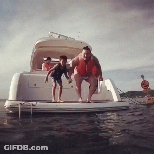 Man And Boy Jumping Off Boat Into Water GIF