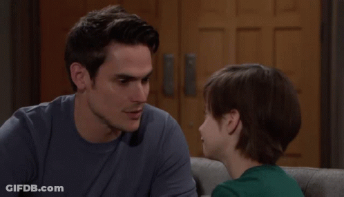 Man And Boy Looking At Each Other On Couch GIF