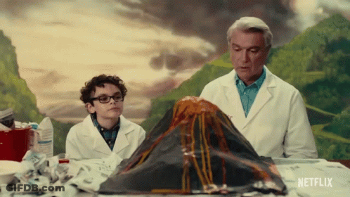 Man And Boy Looking At Volcano Model With Netflix Logo GIF