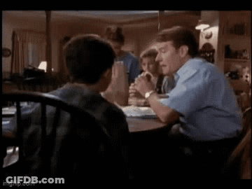 Man And Boy Sitting At Table In Living Room GIF
