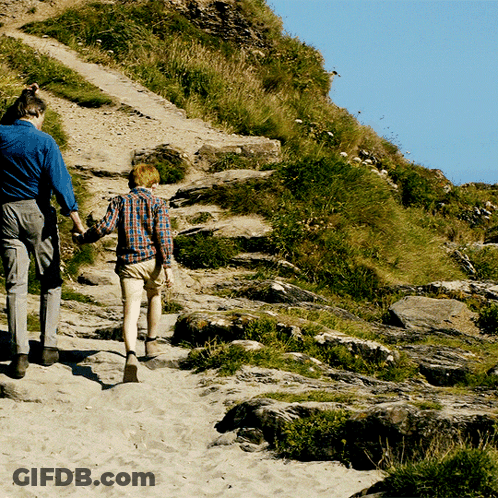Man And Boy Walking Up Hill Holding Hands GIF