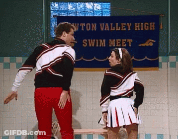 Man And Cheerleader In Front Of Swim Meet Banner GIF