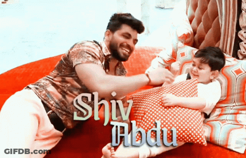 Man And Child Laying On Bed With Shiva GIF