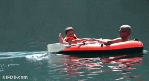 Man And Child On Raft In Water GIF