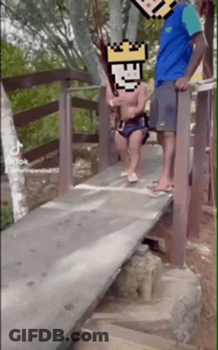 Man And Child Standing On Wooden Bridge With Pixelated Face GIF