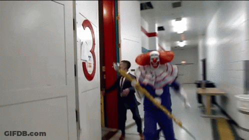 Man And Clown Running Down Hallway With Number 3 GIF