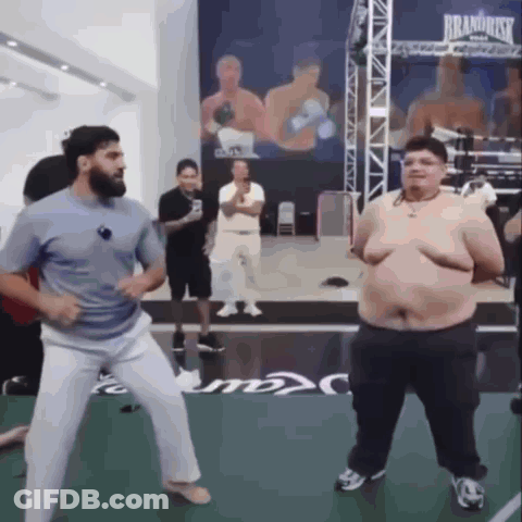 Man And Fat Man Dancing In Boxing Ring Saying Brand Risk GIF