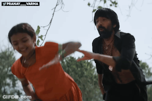 Man And Girl Dancing In Front Of Pranay Varma Sign GIF