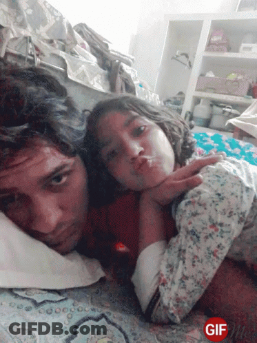 Man And Girl Lying On Bed GIF