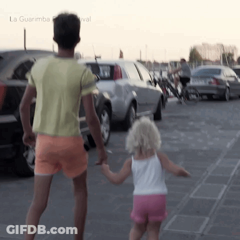 Man And Little Girl Holding Hands At La Guarimba Festival GIF