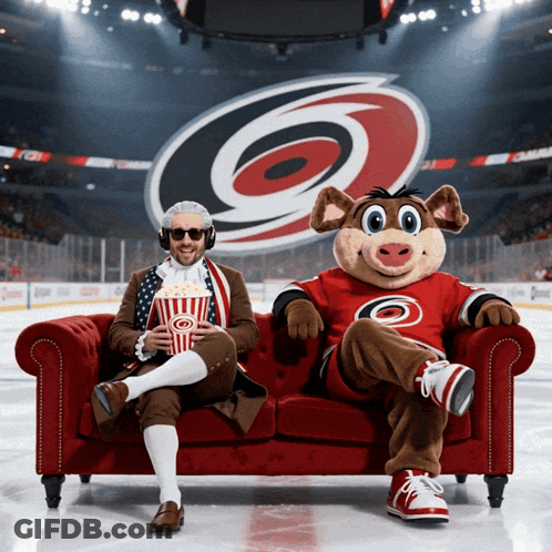 Man And Mascot Sitting On Red Couch GIF