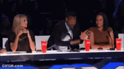 Man And Two Women At Microphones GIF