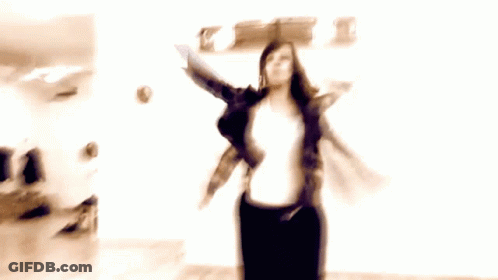 Man And Two Women Dancing In Room With Clock GIF