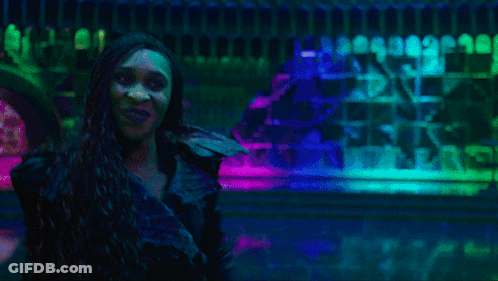 Man And Two Women Dancing Under Purple Lights GIF