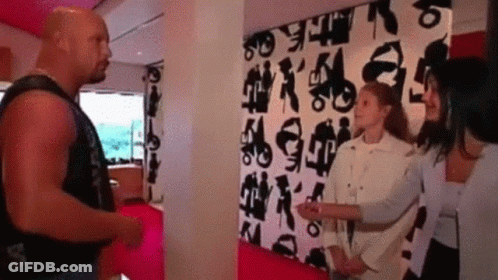 Man And Two Women In Front Of Black And White Letter Wall GIF