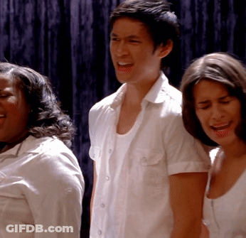 Man And Two Women In Front Of Blue Curtain GIF