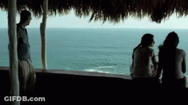 Man And Two Women Looking Over Water GIF