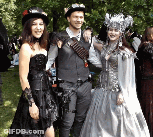 Man And Two Women Posing In Park GIF