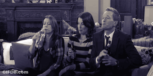 Man And Two Women Sitting On Couch Drinking GIF