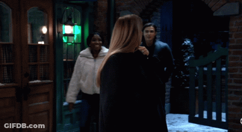 Man And Two Women Smiling In Front Of Brick Building GIF