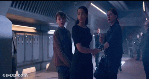 Man And Two Women Standing GIF