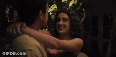 Man And Two Women Standing In Dark Room GIF