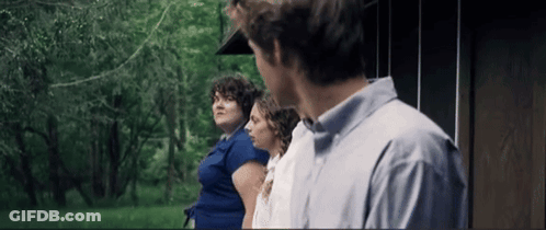Man And Two Women Standing In Front Of A House GIF