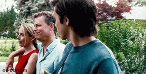 Man And Two Women Standing In Park GIF