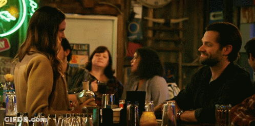 Man And Woman At Bar Under All Neon Sign GIF
