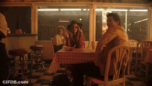 Man And Woman At Diner With Ice Cream Sign GIF