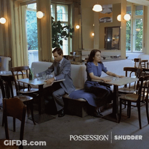 Man And Woman At Restaurant With Possession Shudder GIF