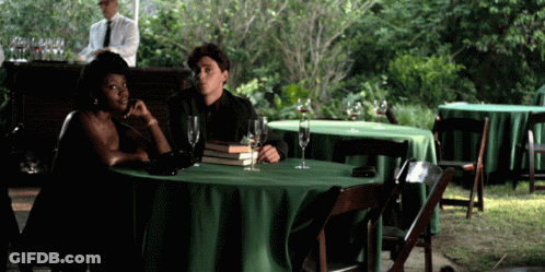 Man And Woman At Table With Green Tablecloth GIF