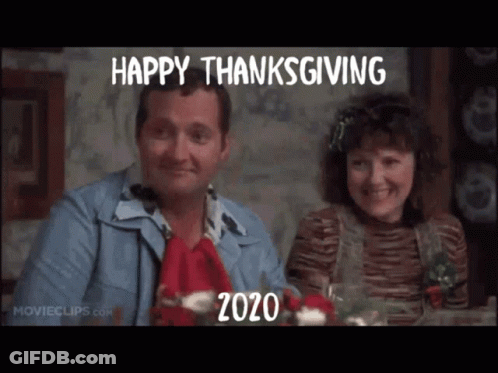 Man And Woman At Table With Happy Thanksgiving 2020 Sign GIF
