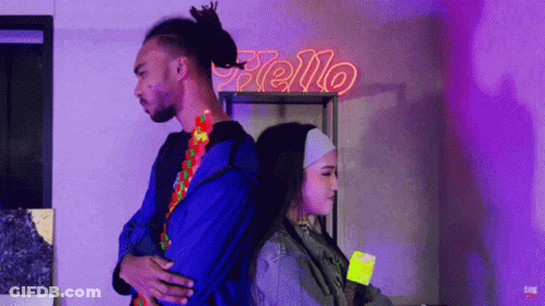 Man And Woman Back To Back Under Neon Sign Saying Hello GIF