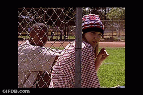 Man And Woman Behind Chain Link Fence In Park GIF