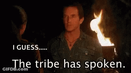 Man And Woman By Fire Saying Tribe Has Spoken GIF