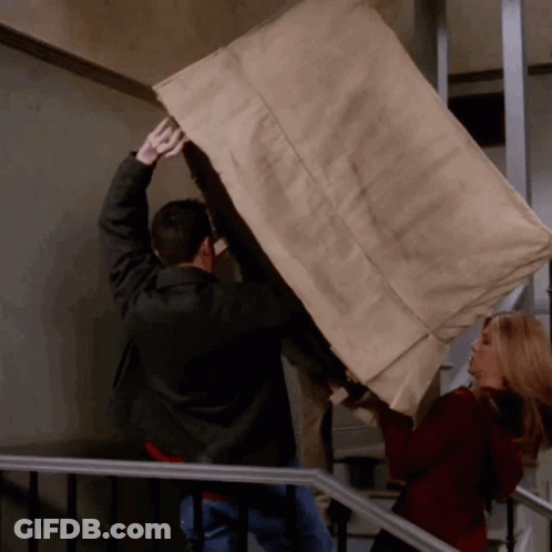 Man And Woman Carrying Furniture Up Staircase GIF