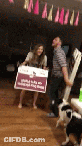 Man And Woman Carrying Nine Day Prints Sign GIF