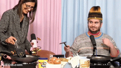 Man And Woman Cooking With Arc Spatula GIF