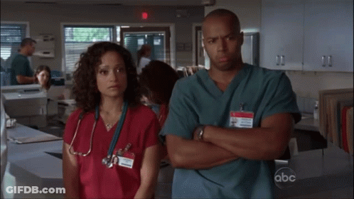 Man And Woman Crossed Arms With ABC Badge GIF