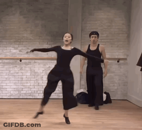 Man And Woman Dancing Against Brick Wall GIF