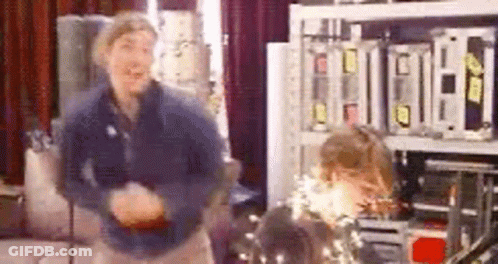 Man And Woman Dancing Among Electronics GIF