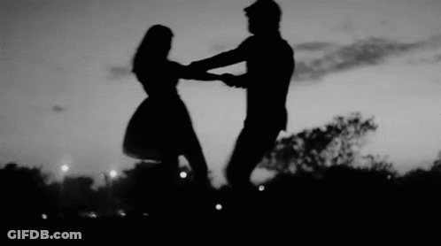 Man And Woman Dancing At Sunset In Park GIF